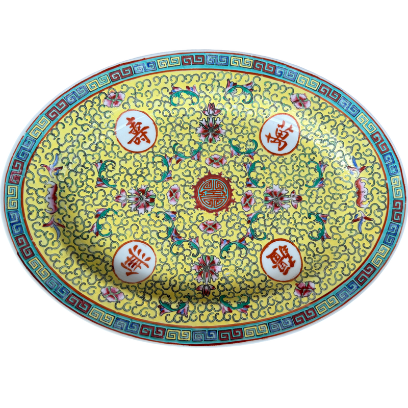 Vintage Famille Jaune Chinese porcelain platter with yellow background, floral motifs, scrolling pattern details, and colorful geometric border. One-of-a-kind chinoiserie decorative accent for shelves, walls, or tabletops.