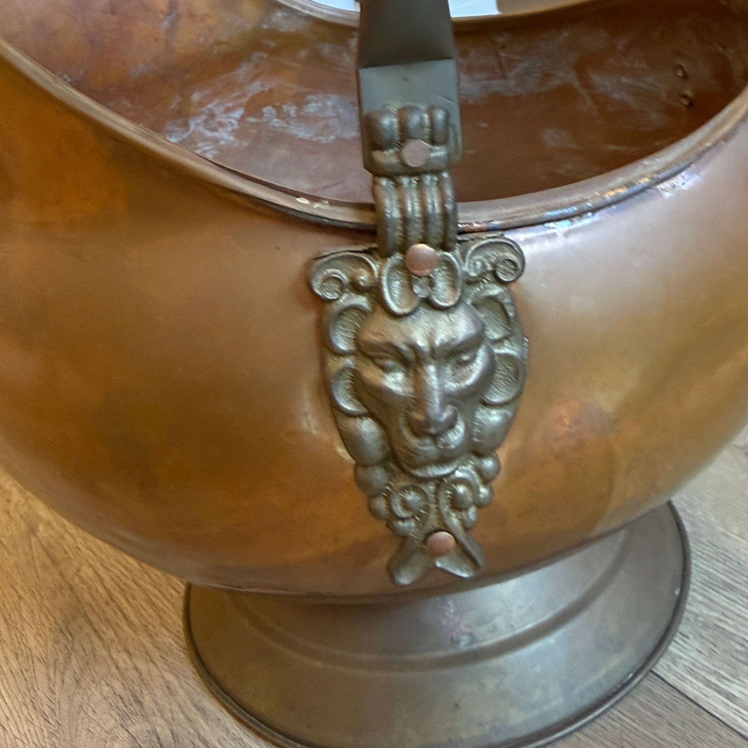 Decorative bronze door handle on a wooden door