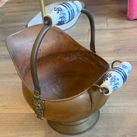 Decorative wall light fixture with brown shade and blue and white floral design on wooden panel