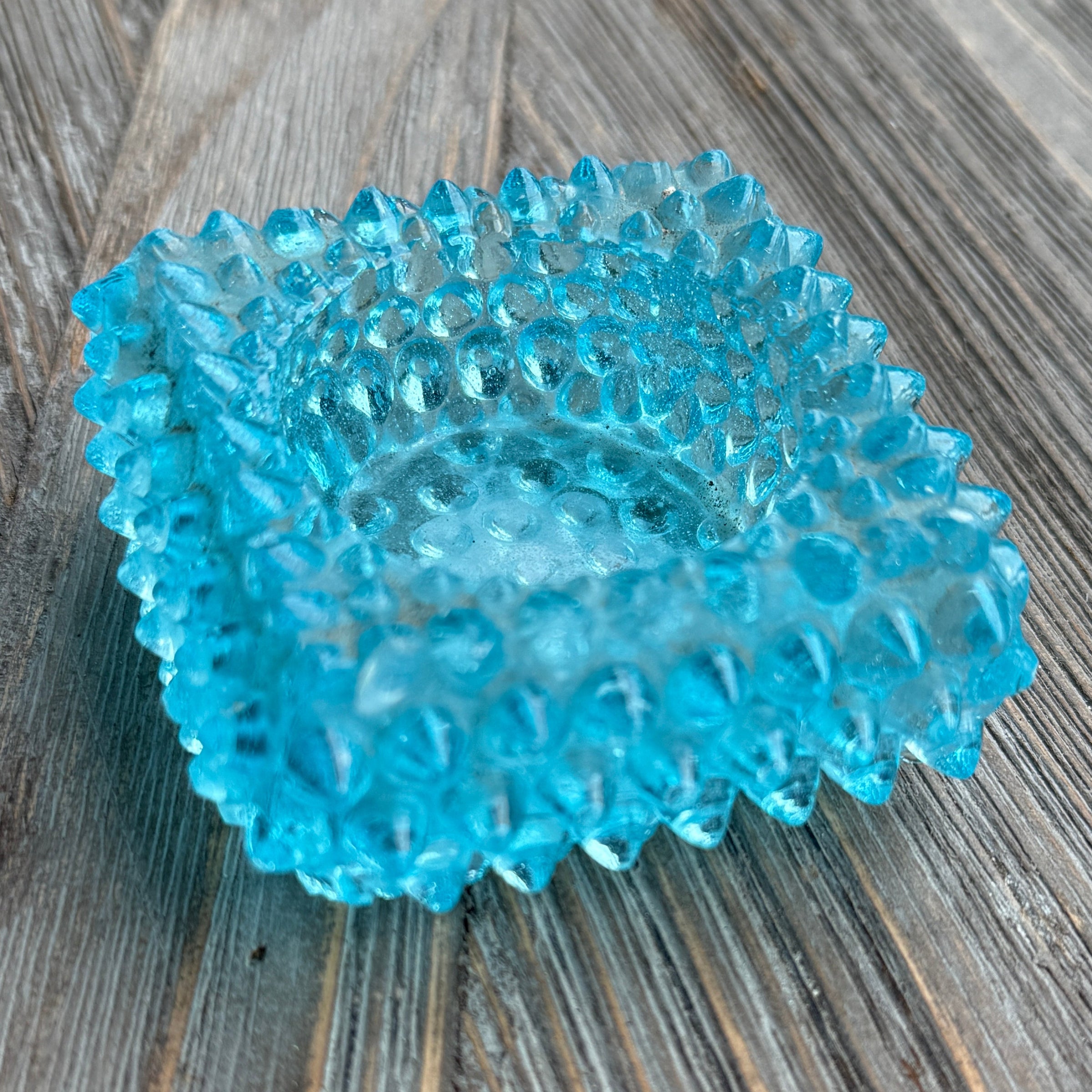 Blue textured object on a wooden surface