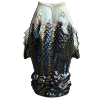 Decorative vase shaped like two fish on a white background