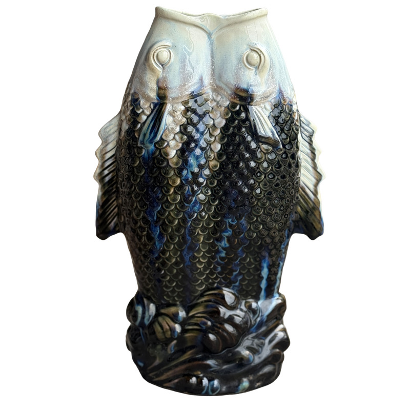 Decorative vase shaped like two fish on a white background