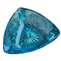 Blue glass dish with intricate patterns on a white background