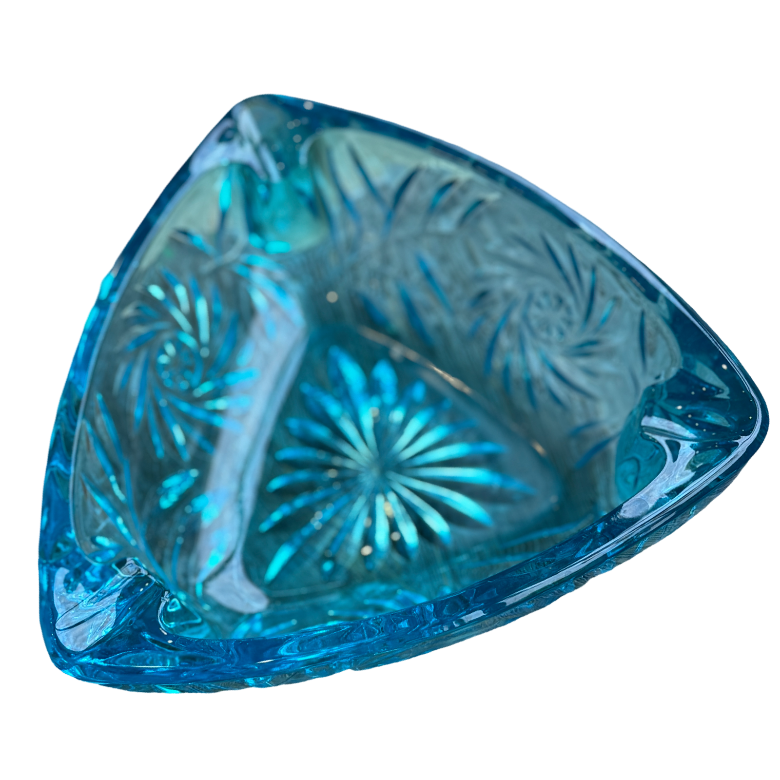Blue glass dish with intricate patterns on a white background
