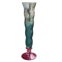 Multicolored glass vase with a gradient from clear to blue and pink on a white background