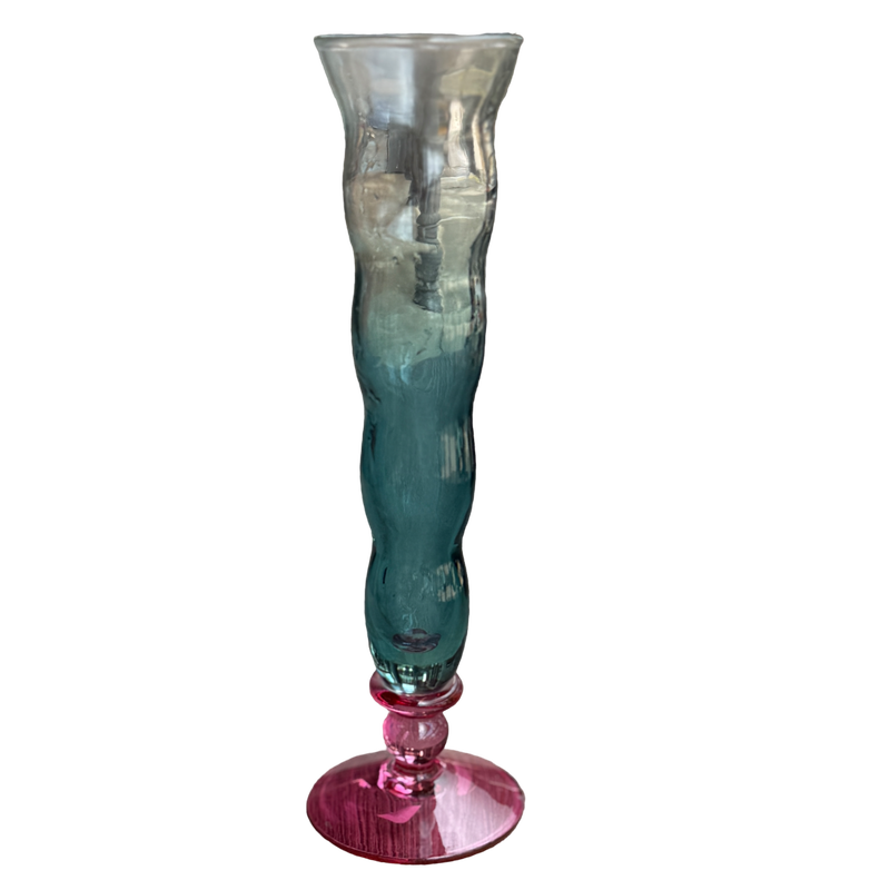 Multicolored glass vase with a gradient from clear to blue and pink on a white background