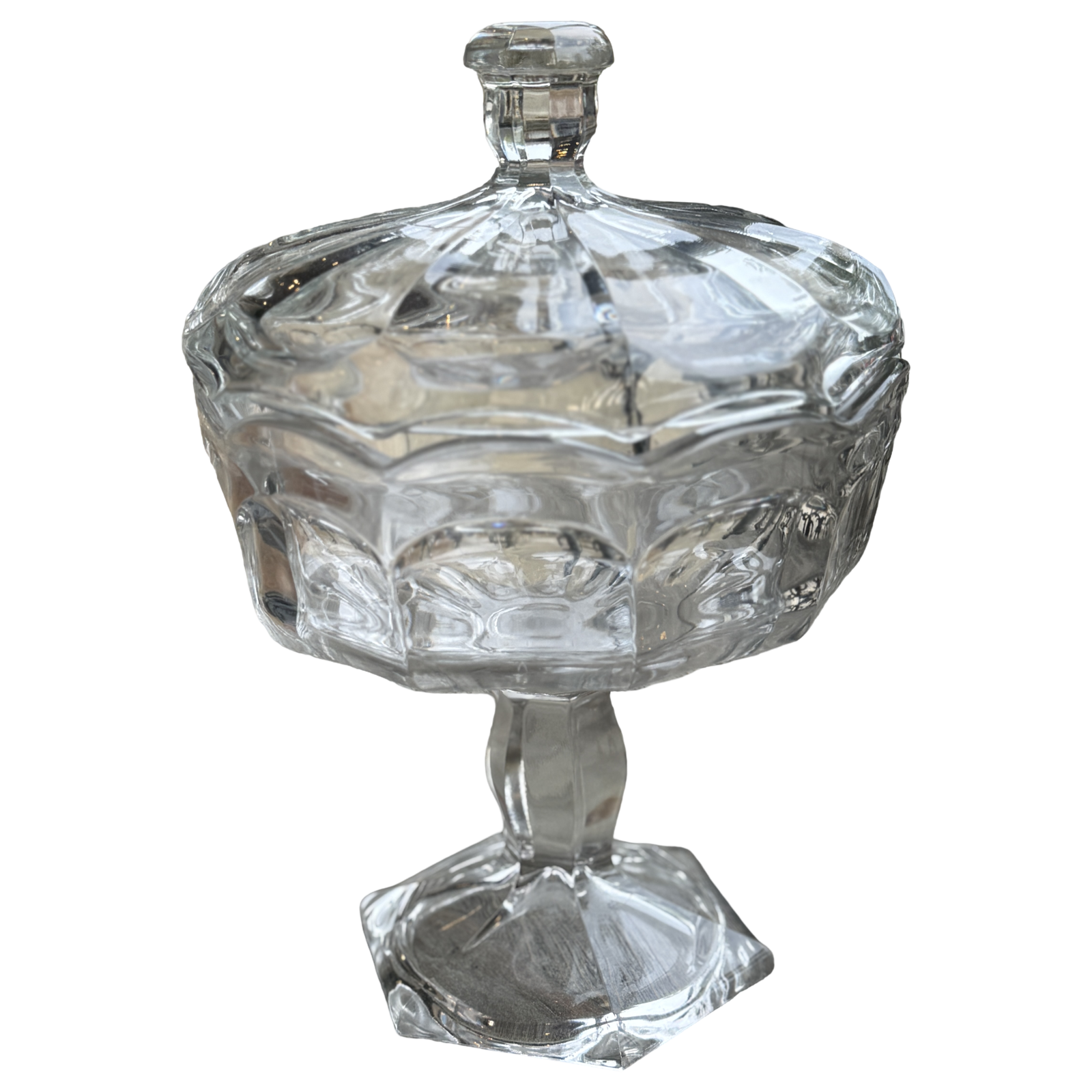 Clear glass candy dish with a lid on a white background