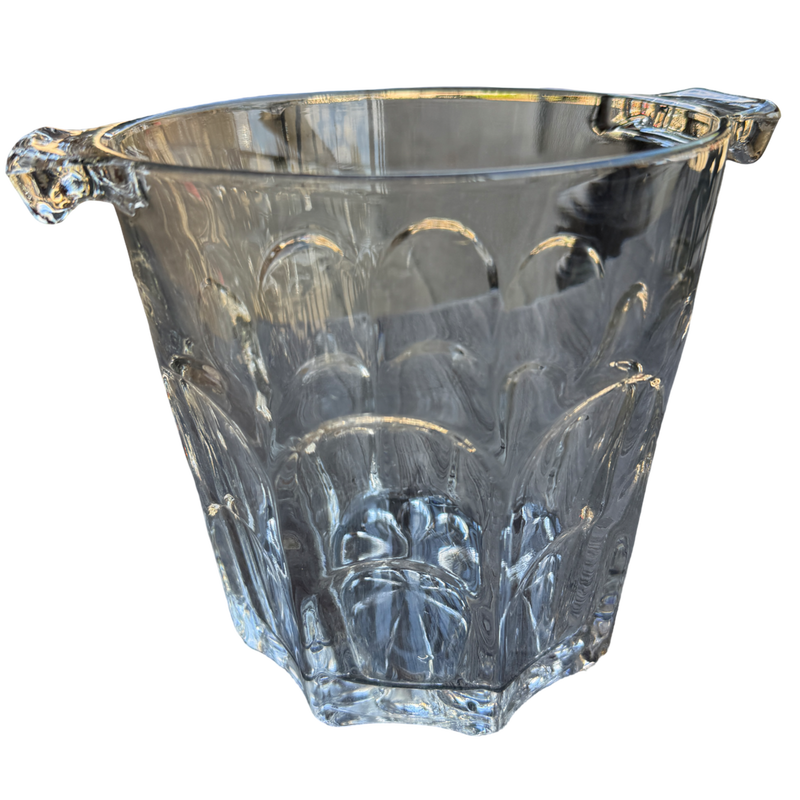 Clear glass ice bucket with decorative handles on a white background