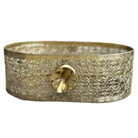 Decorative brass tray with intricate patterns on a white background