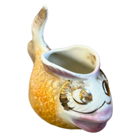 Ceramic fish-shaped vase with a smiling face on a white background