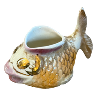 Fish-shaped ceramic container on a white background