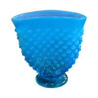 Blue textured glass vase on a white background