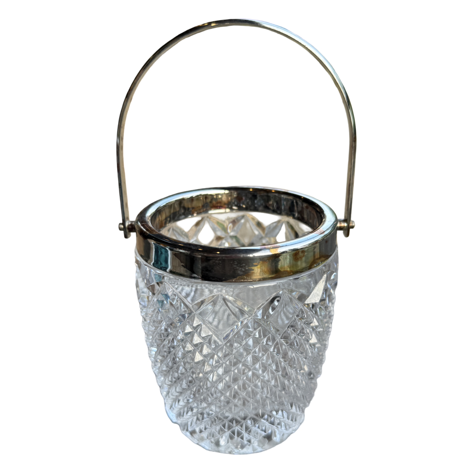 Clear glass ice bucket with silver rim and handle on a white background