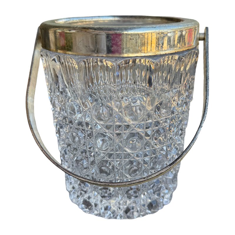 Clear glass ice bucket with silver rim on a white background
