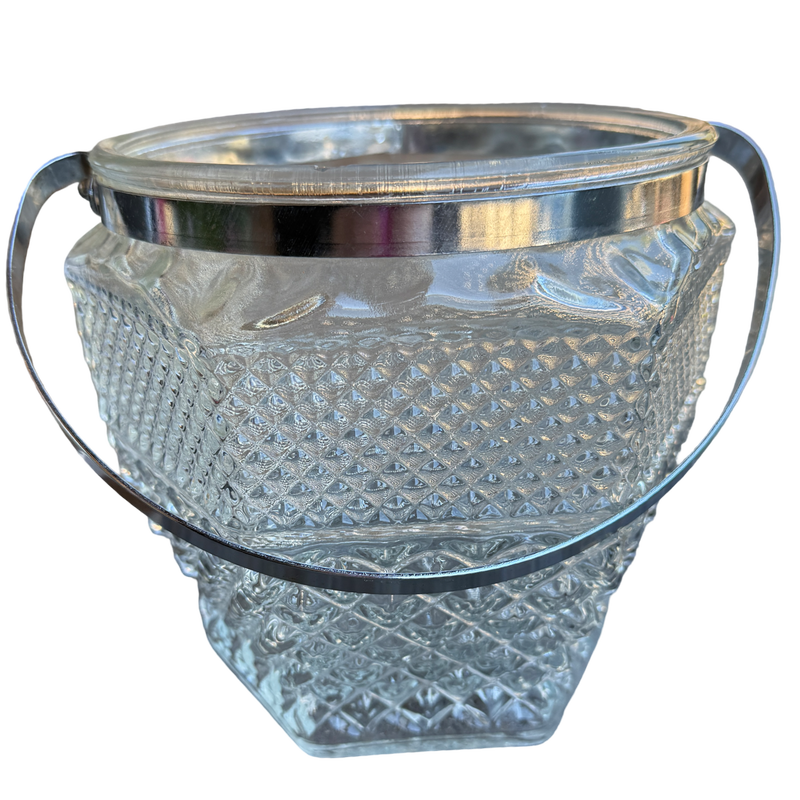 Clear glass ice bucket with silver rim on a white background