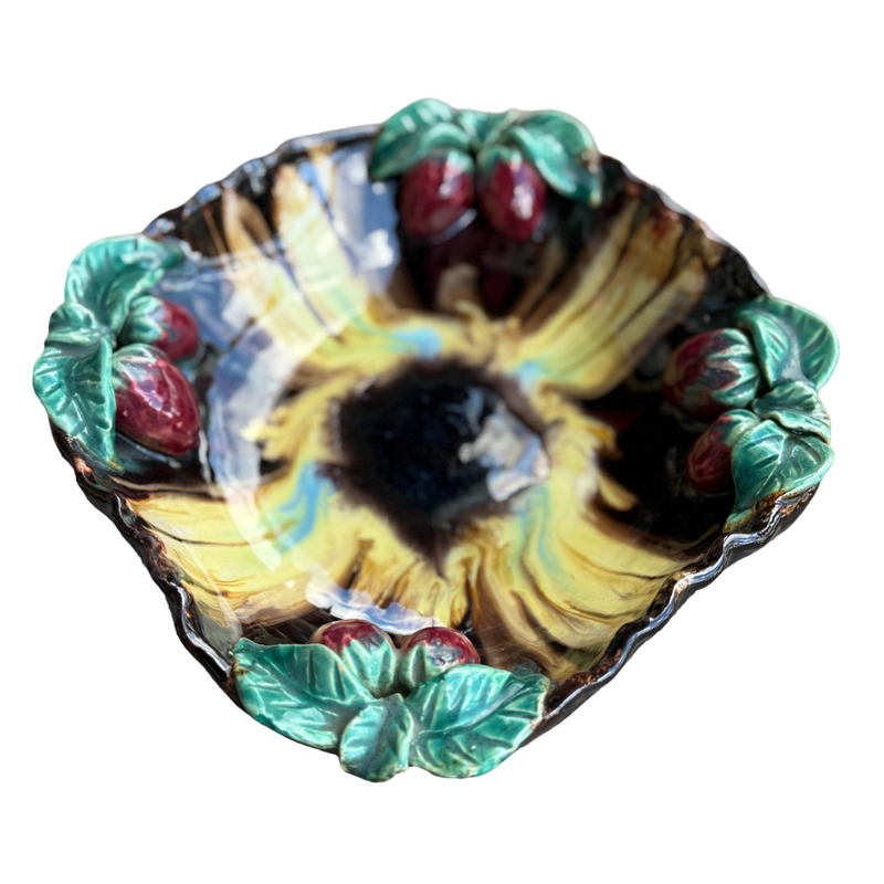 Decorative ceramic bowl with sunflower and berry design on a white background