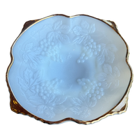 Decorative white bowl with floral patterns and gold rim on a white background