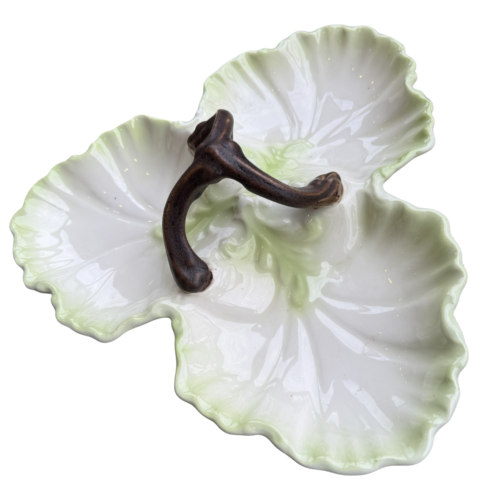 Decorative ceramic leaf-shaped dish with a brown hook on a white background