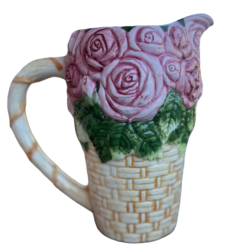 Ceramic pitcher with pink roses and a woven pattern on a white background