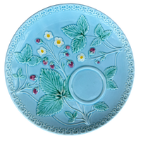 Decorative plate with strawberry design on a light blue background