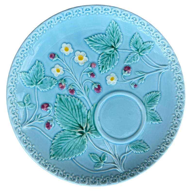 Decorative plate with strawberry design on a light blue background