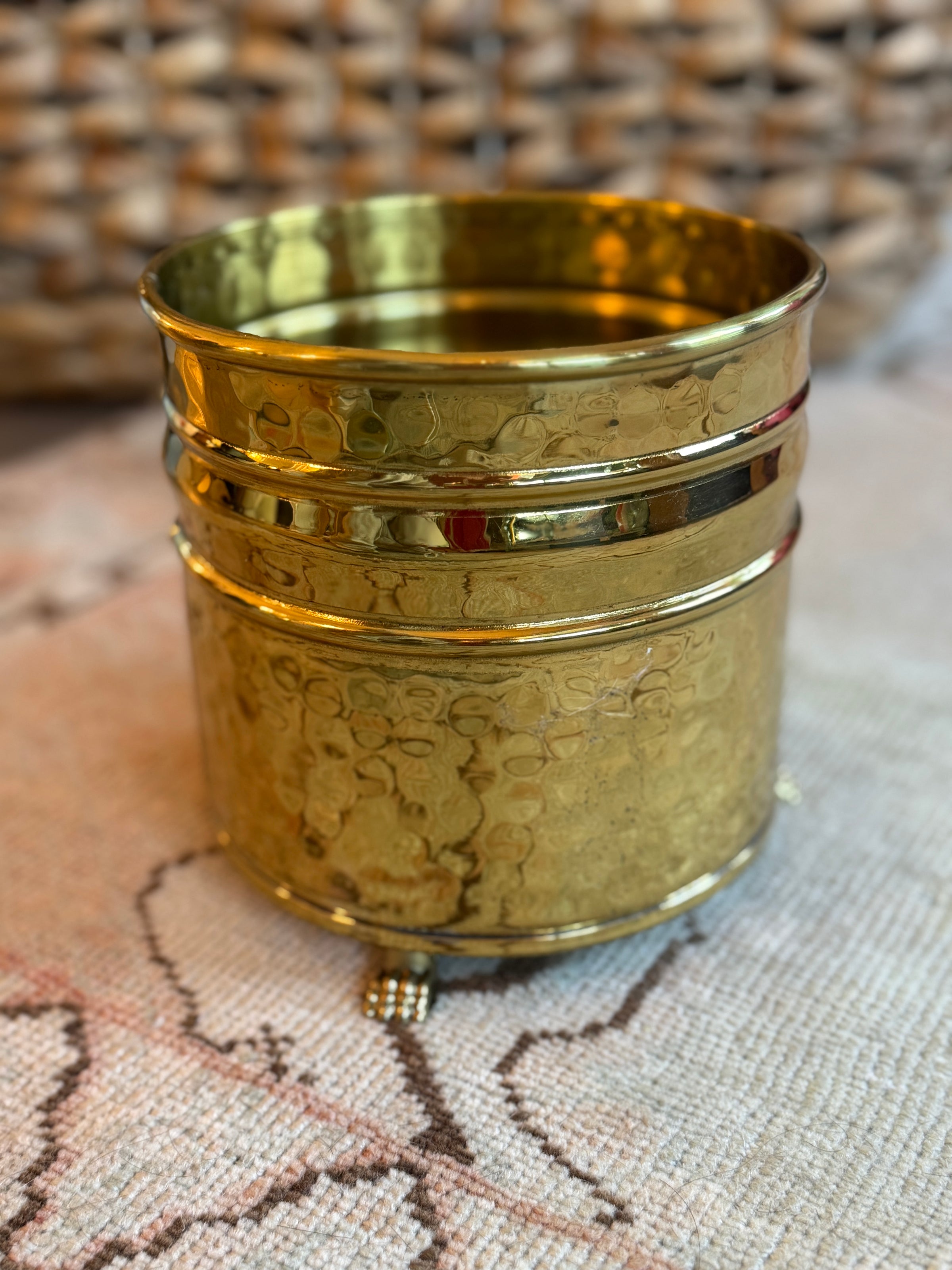 Gold textured container on a textured surface with woven background