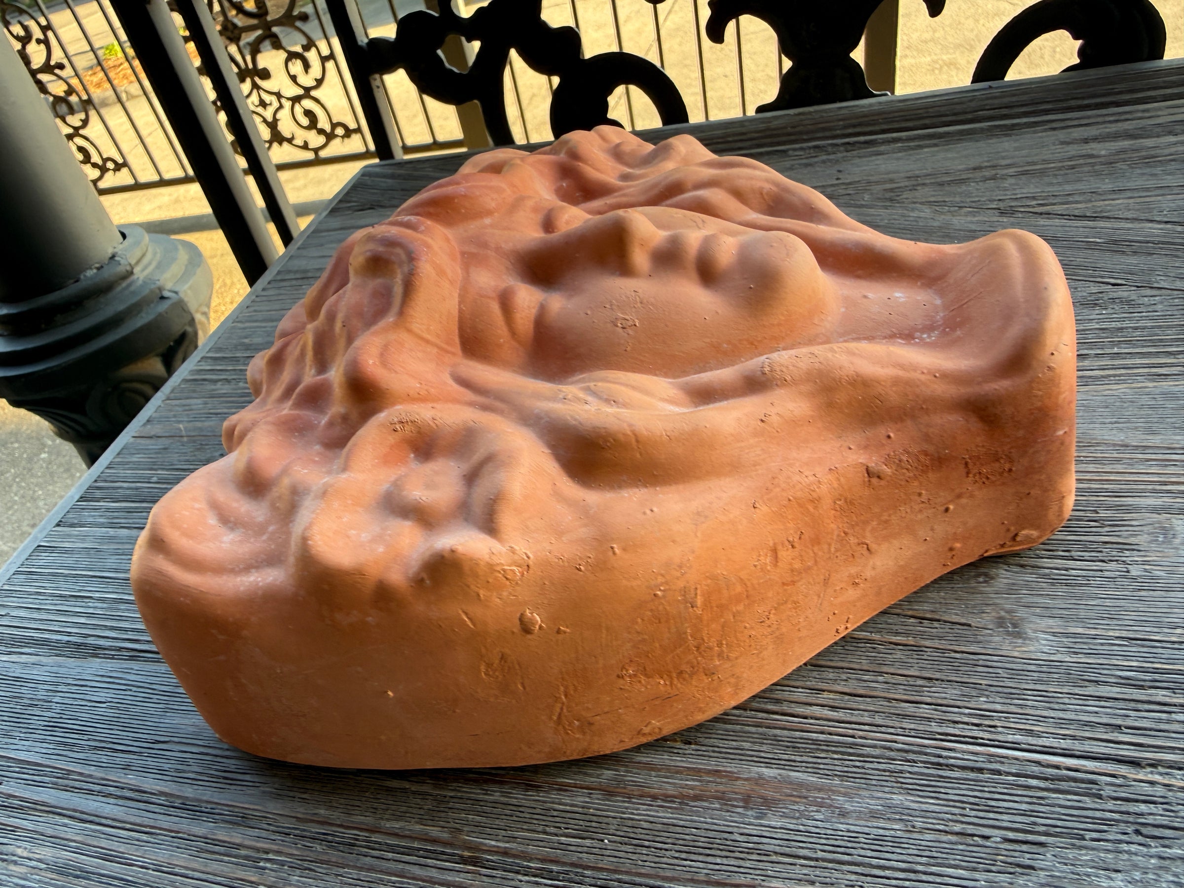 Brown soap bar with a unique texture on a wooden surface