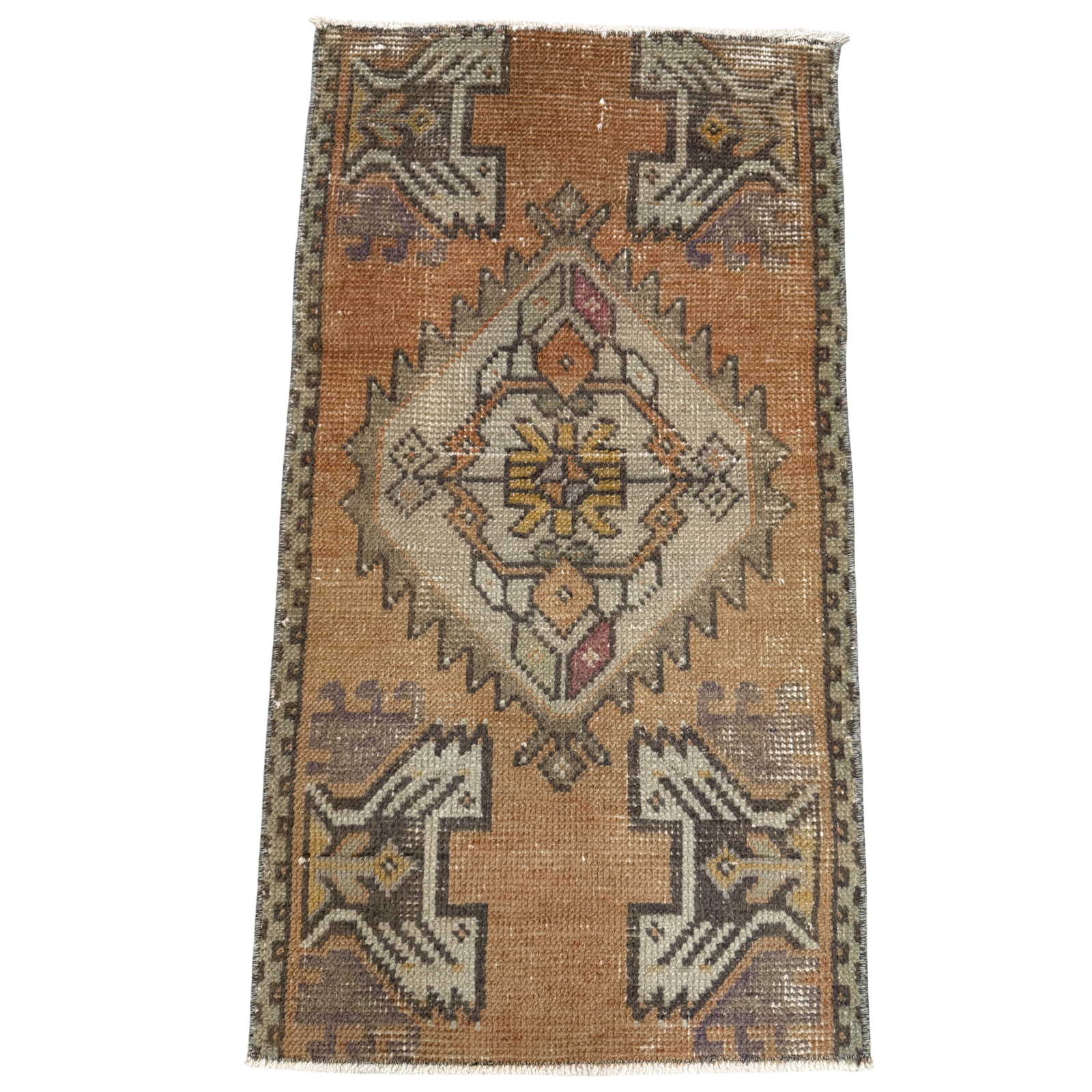 Vintage-style rug with geometric pattern on a plain background