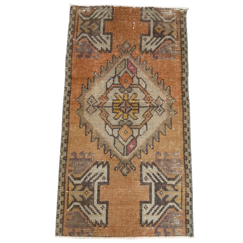 Vintage-style rug with geometric pattern on a plain background