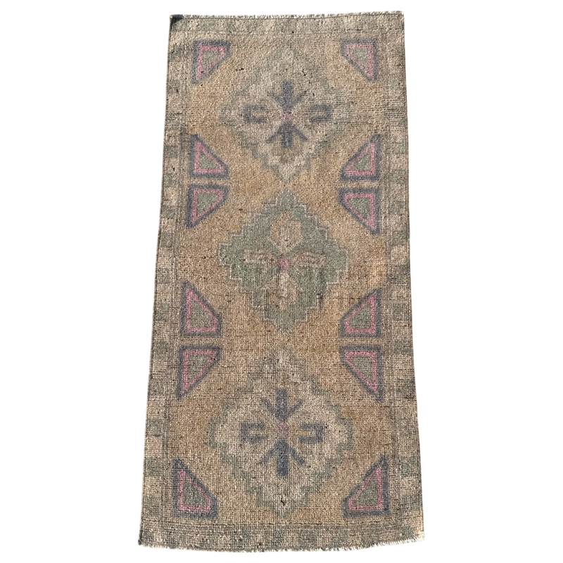 Vintage-style rug with geometric pattern on a white background