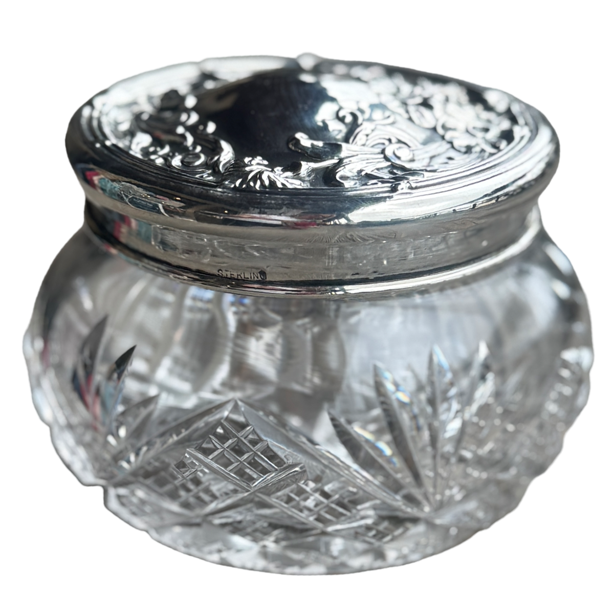 Clear glass jar with silver lid on a white background