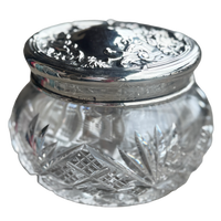 Clear glass jar with silver lid on a white background
