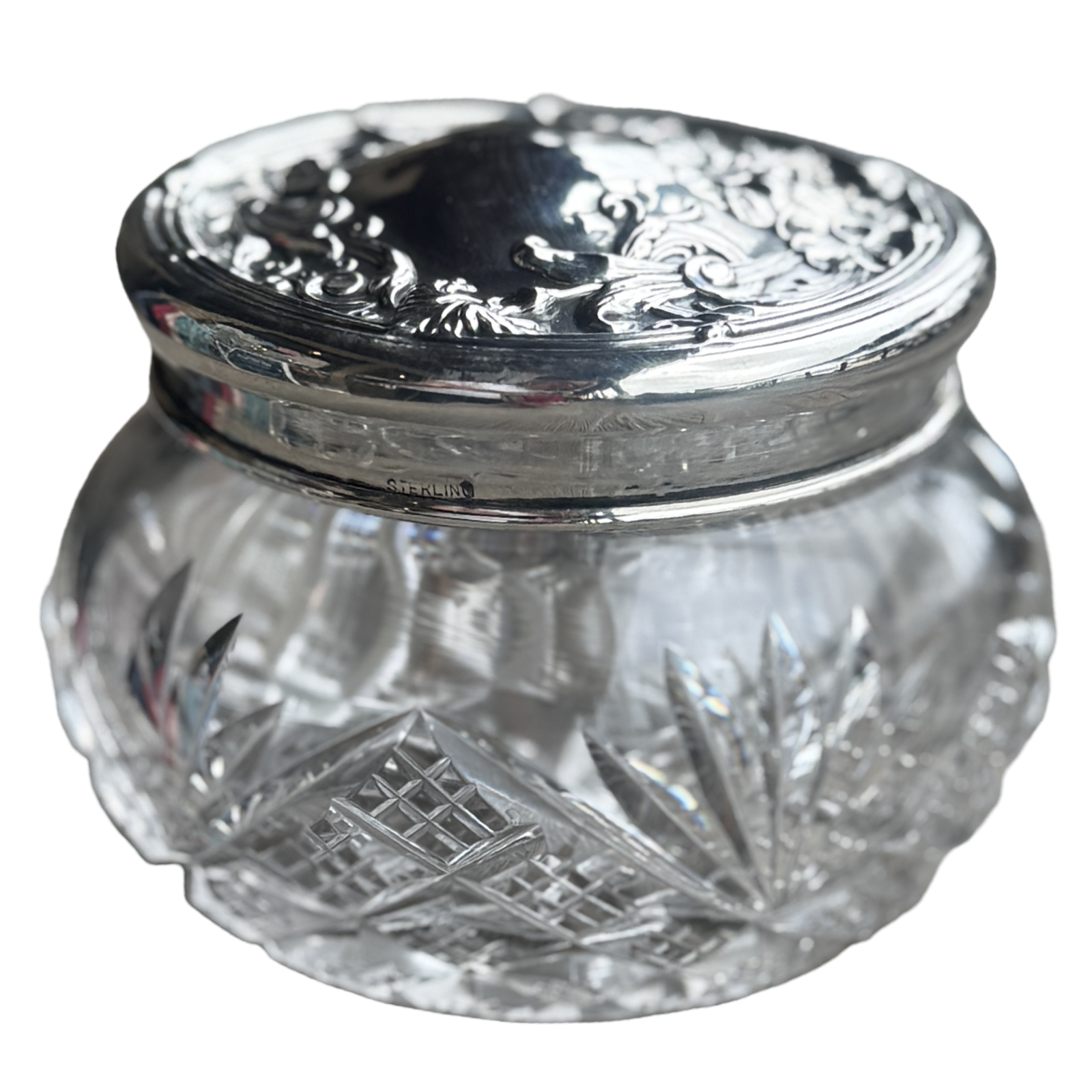 Clear glass jar with silver lid on a white background