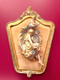 Decorative wall piece with a woman and child design on a red background