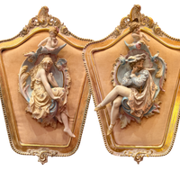 Decorative wall art pieces with classical female figures and ornate gold frames.