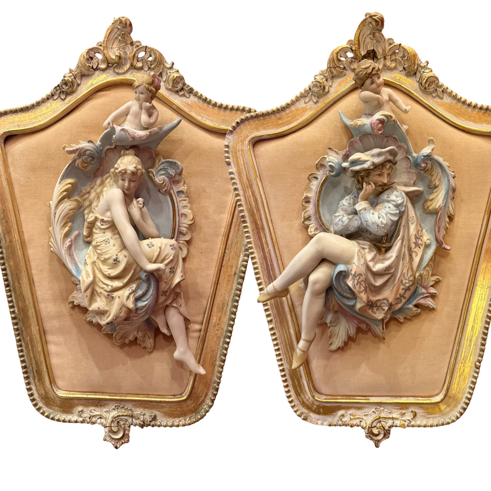 Decorative wall art pieces with classical female figures and ornate gold frames.