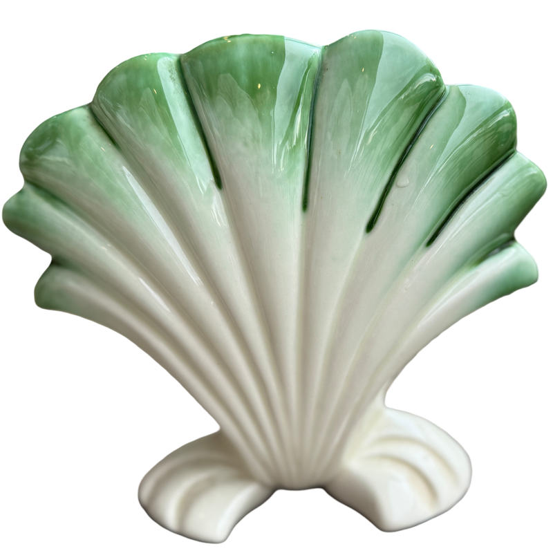 Shell-shaped ceramic vase with a green top and white base on a white background