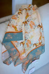 Folded fabric with animal pattern on a white surface